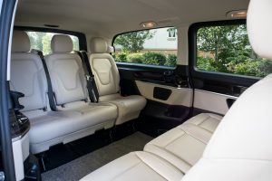 Cream interior of Black Mercedes V Class rear cabin